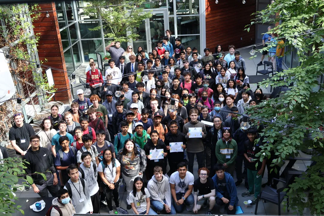 A high-angle shot of all the attendees standing in the courtyard, facing the camera
